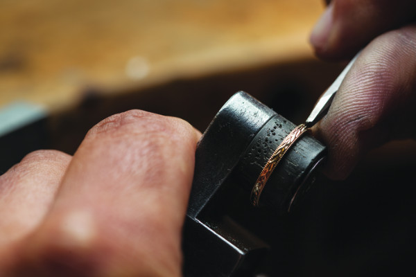 someone engraving jewelry