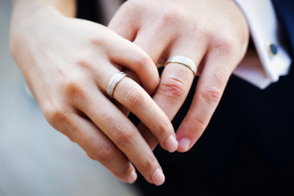 couple wearing engagement ring